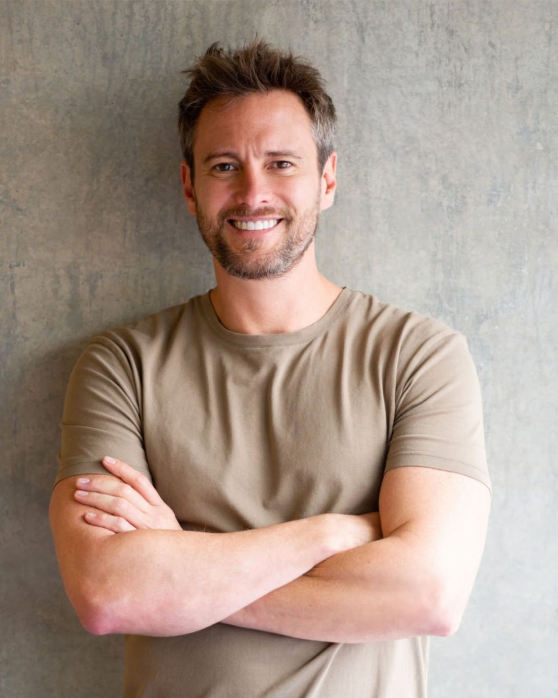 Man standing confidently with arms crossed