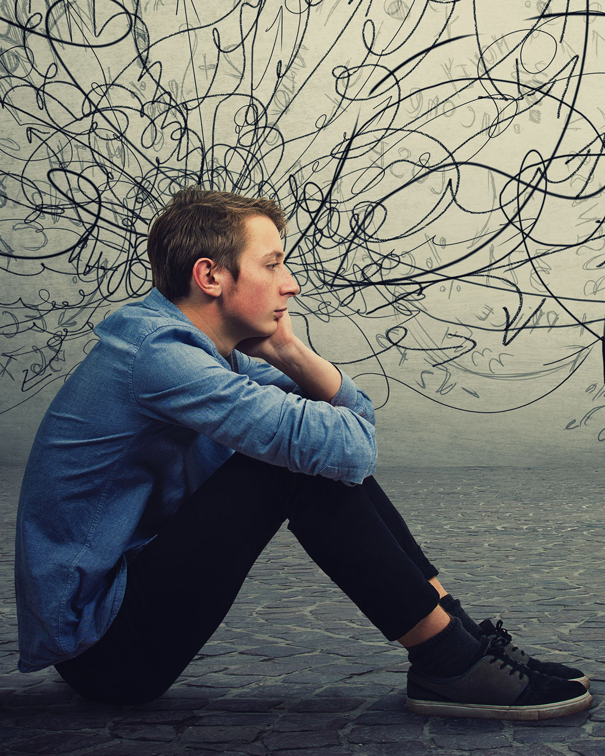 Young man sitting on the floor looking stressed and hopeless